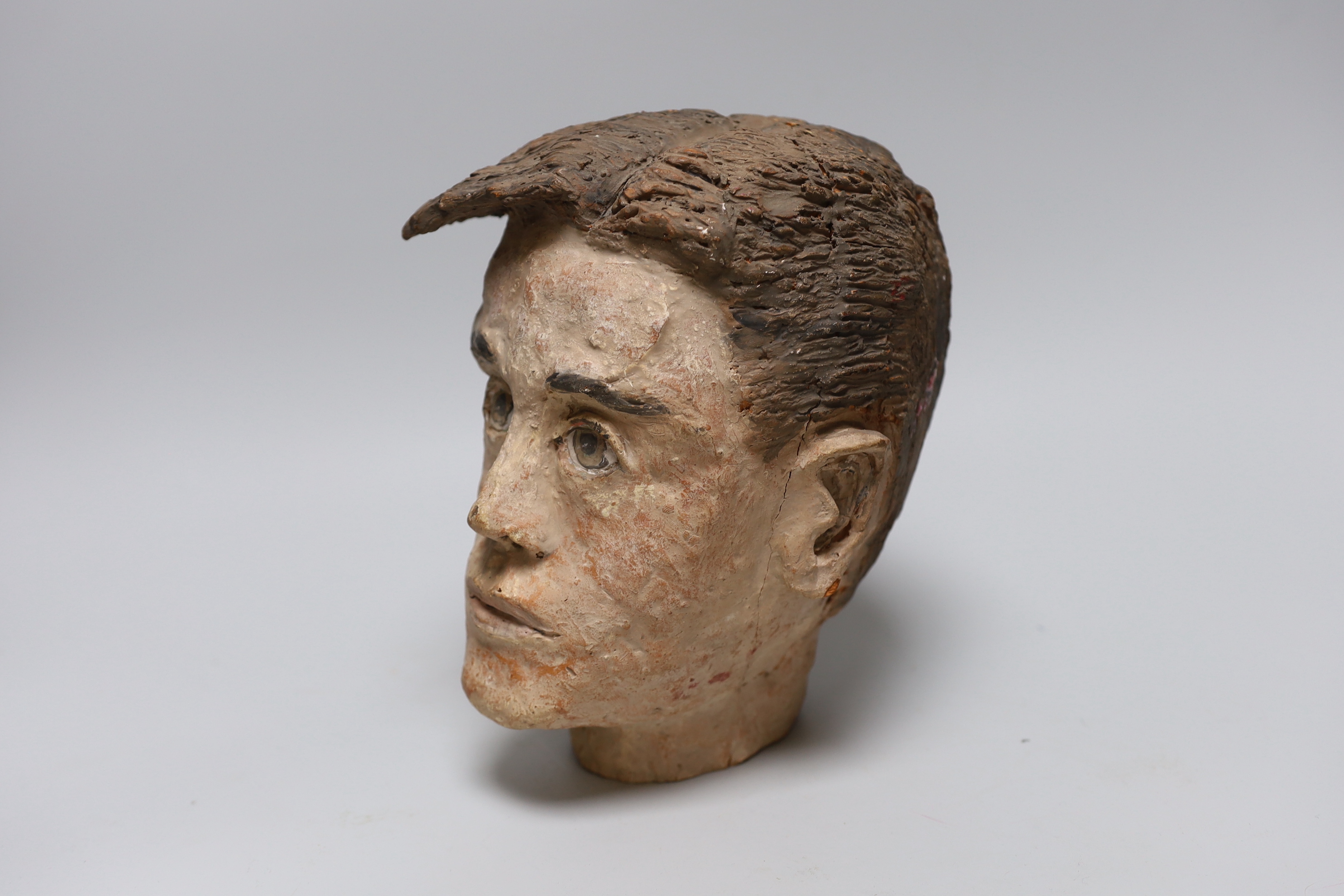 A terracotta bust of a boy, back of neck signed, 23cm